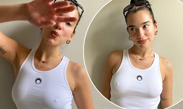 Dua Lipa poses braless in a tight white tank top after revealing she’s excited to become an ‘auntie’