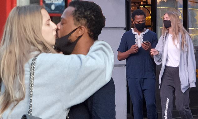 Married footballer Patrice Evra shares a steamy kiss with model girlfriend Margaux Alexandra