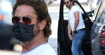 Gerard Butler wears a mask during a solo outing… following split from girlfriend Morgan Brown